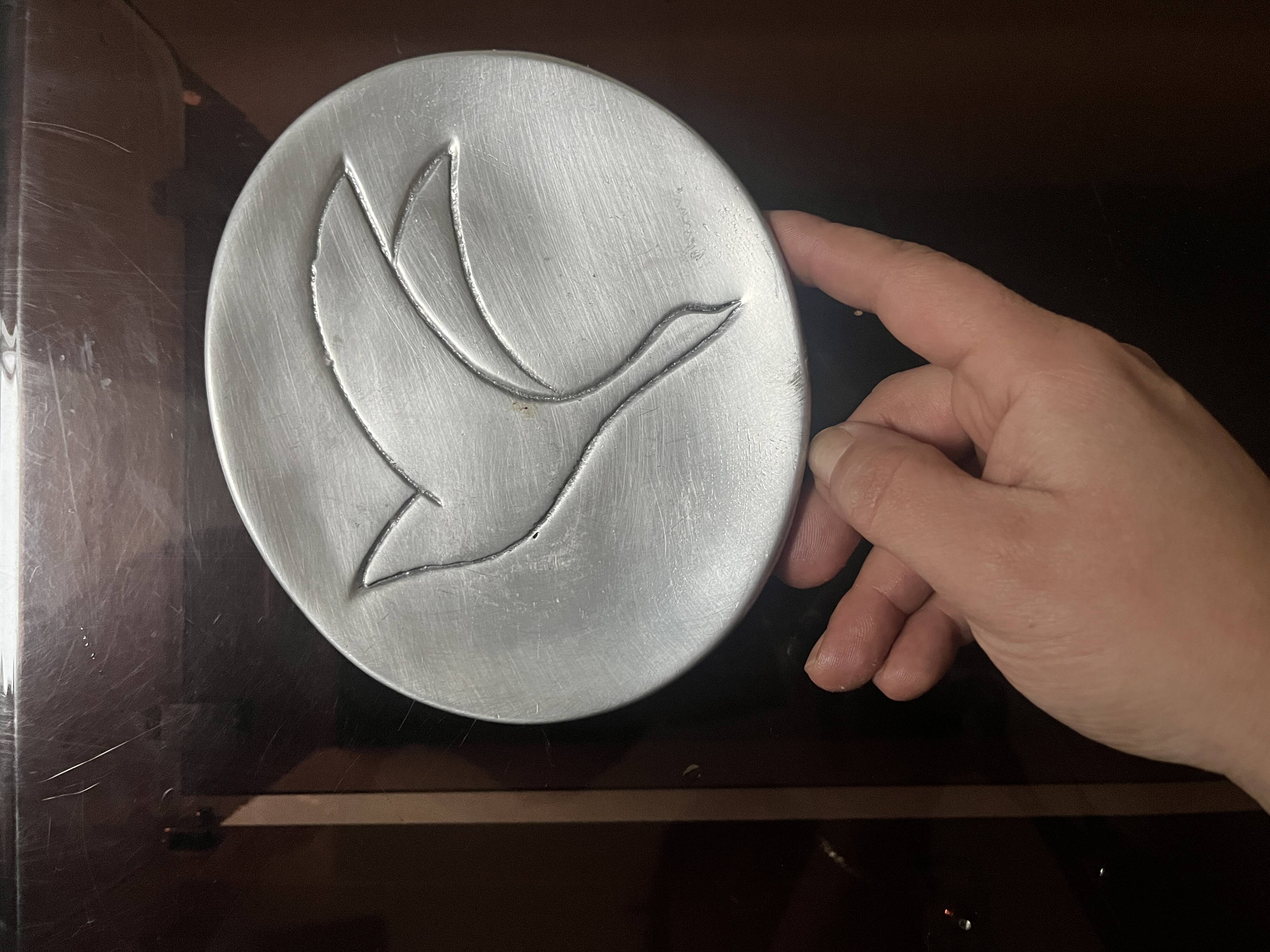 polished aluminum pocket emptier, signed and stamped in the mass