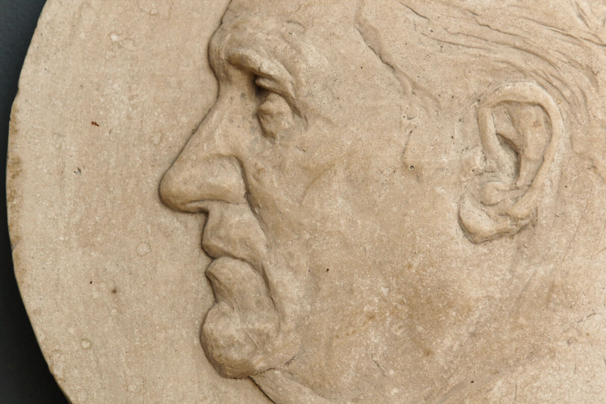 Old plaster medallion, man profile