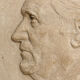 Old plaster medallion, man profile