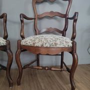 Pair of Provençal armchairs in brown wood and floral fabric.
