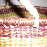 Round and colorful straw basket with handles