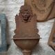 Old cast iron wall fountain with lion's head