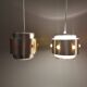 Two Space-Age hanging lamps, in silver-coloured aluminium with orange prisms.