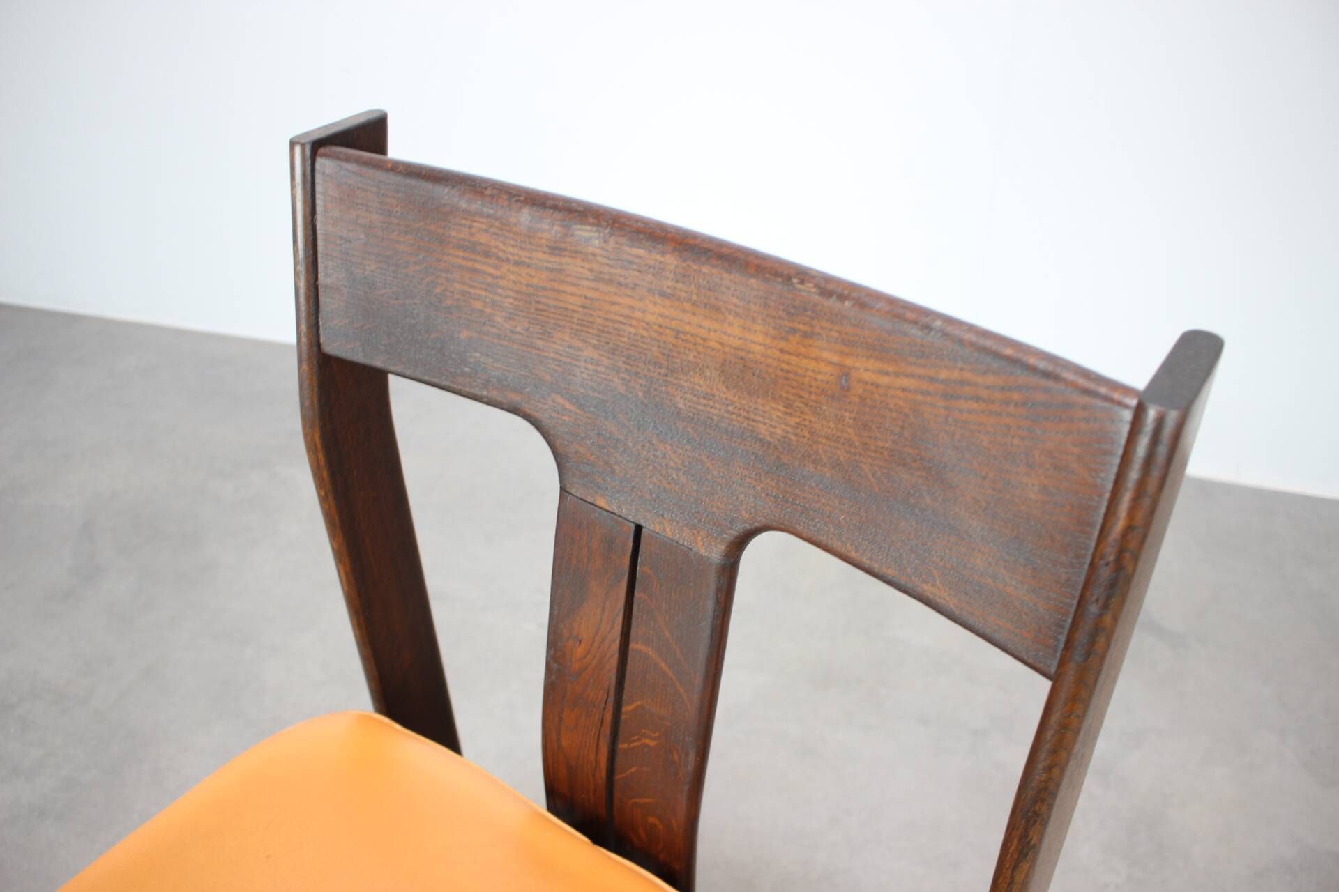 Vintage German sculptural chair from the 1970s in wood with orange faux leather.
