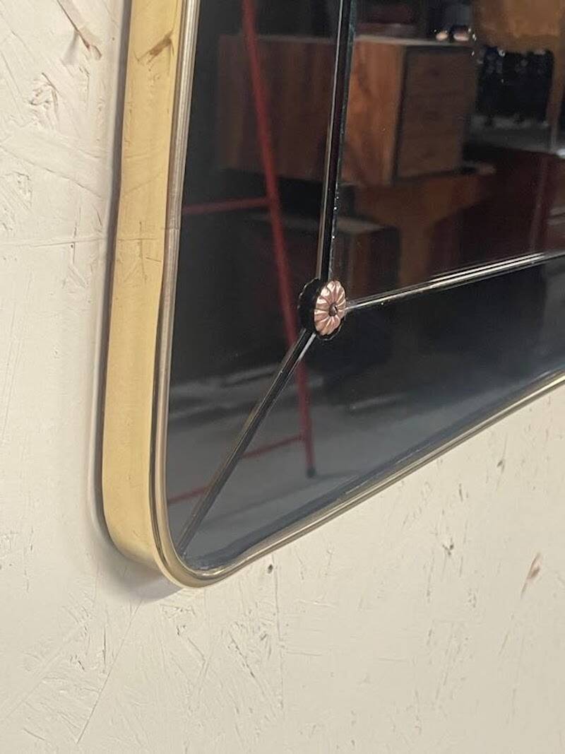1950s double-thickness wall mirror with brass profile and supports.