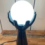 Lamp hands holding a globe