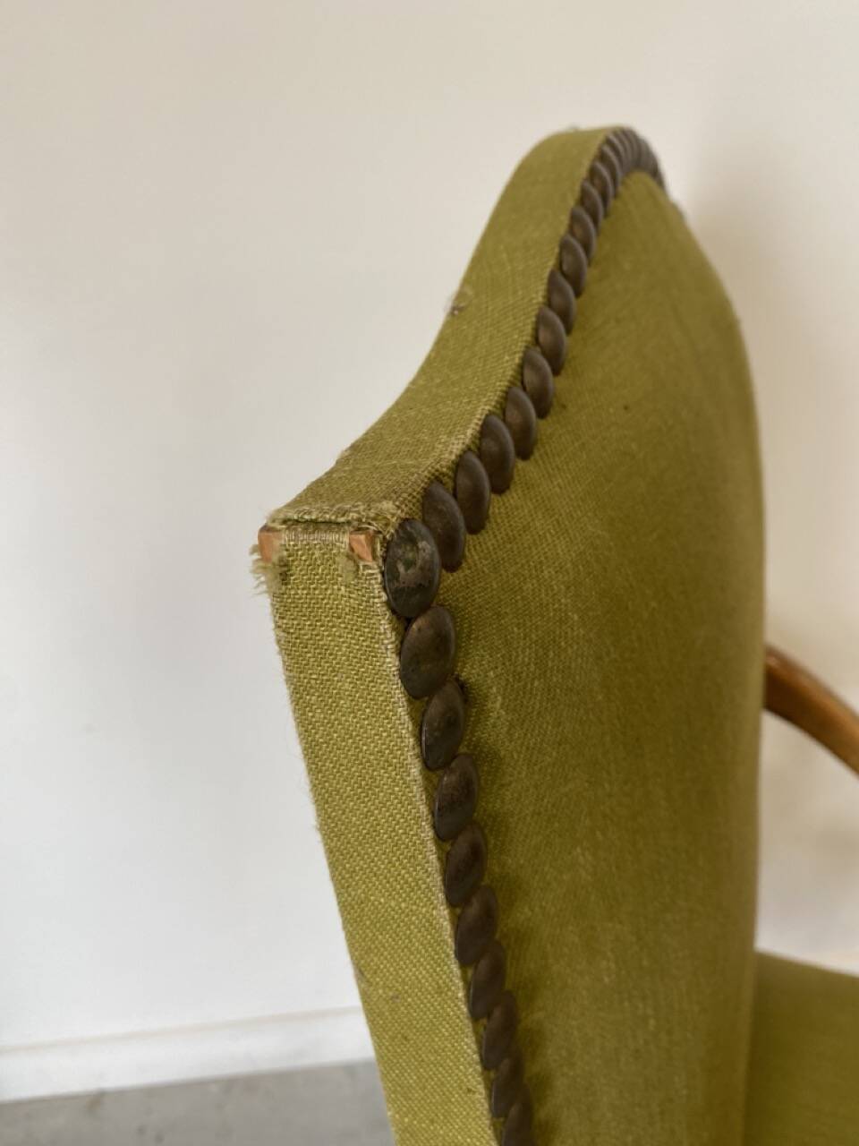Olive green upholstered armchairs with studs