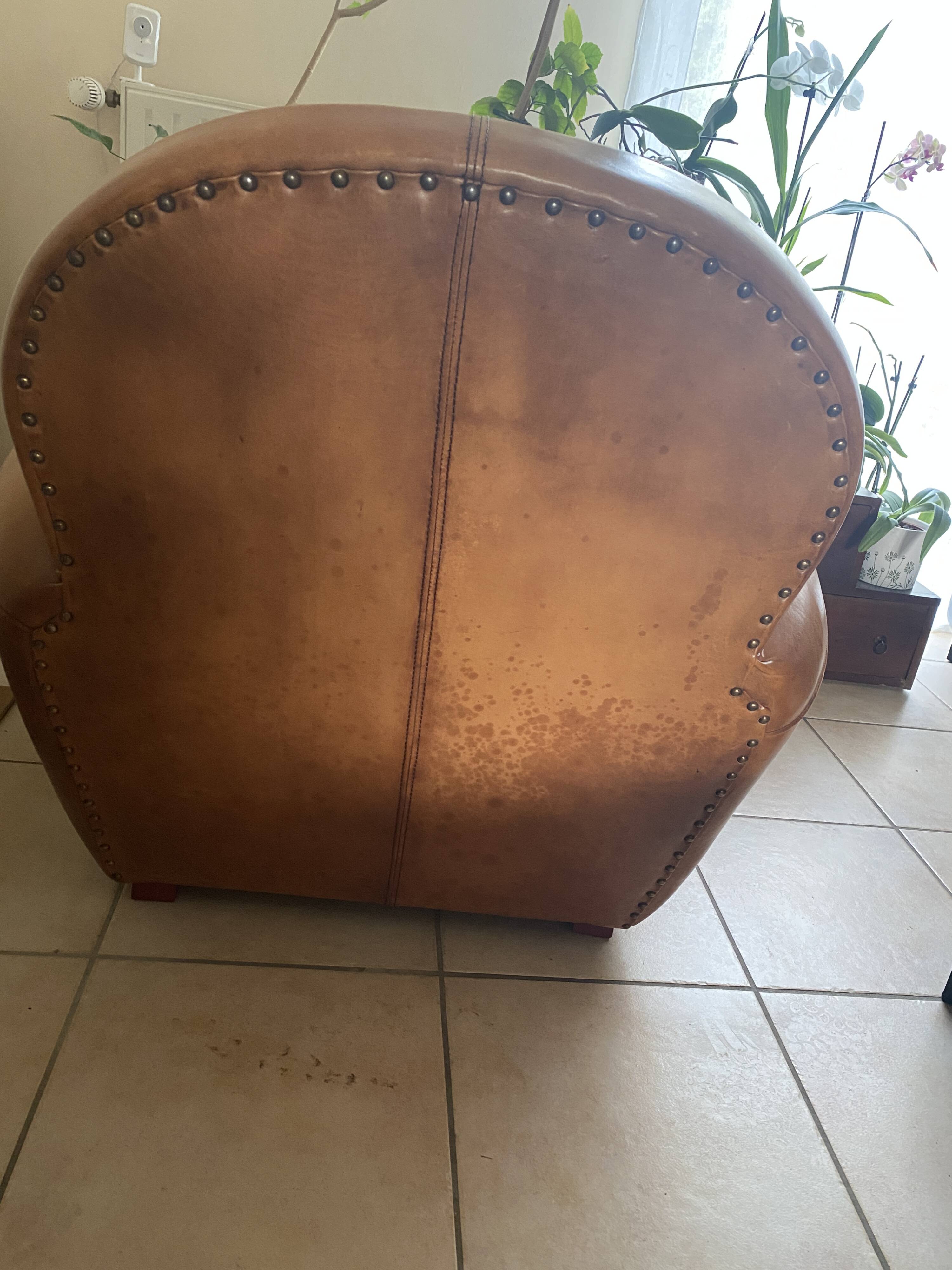 Brown leather club armchairs with an antique finish.