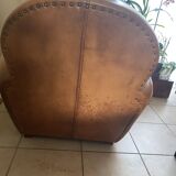 Brown leather club armchairs with an antique finish.