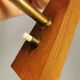 A set of Danish wall lights in champagne coloured glass with brass and teak.