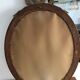 Old oval mirror with a pediment
