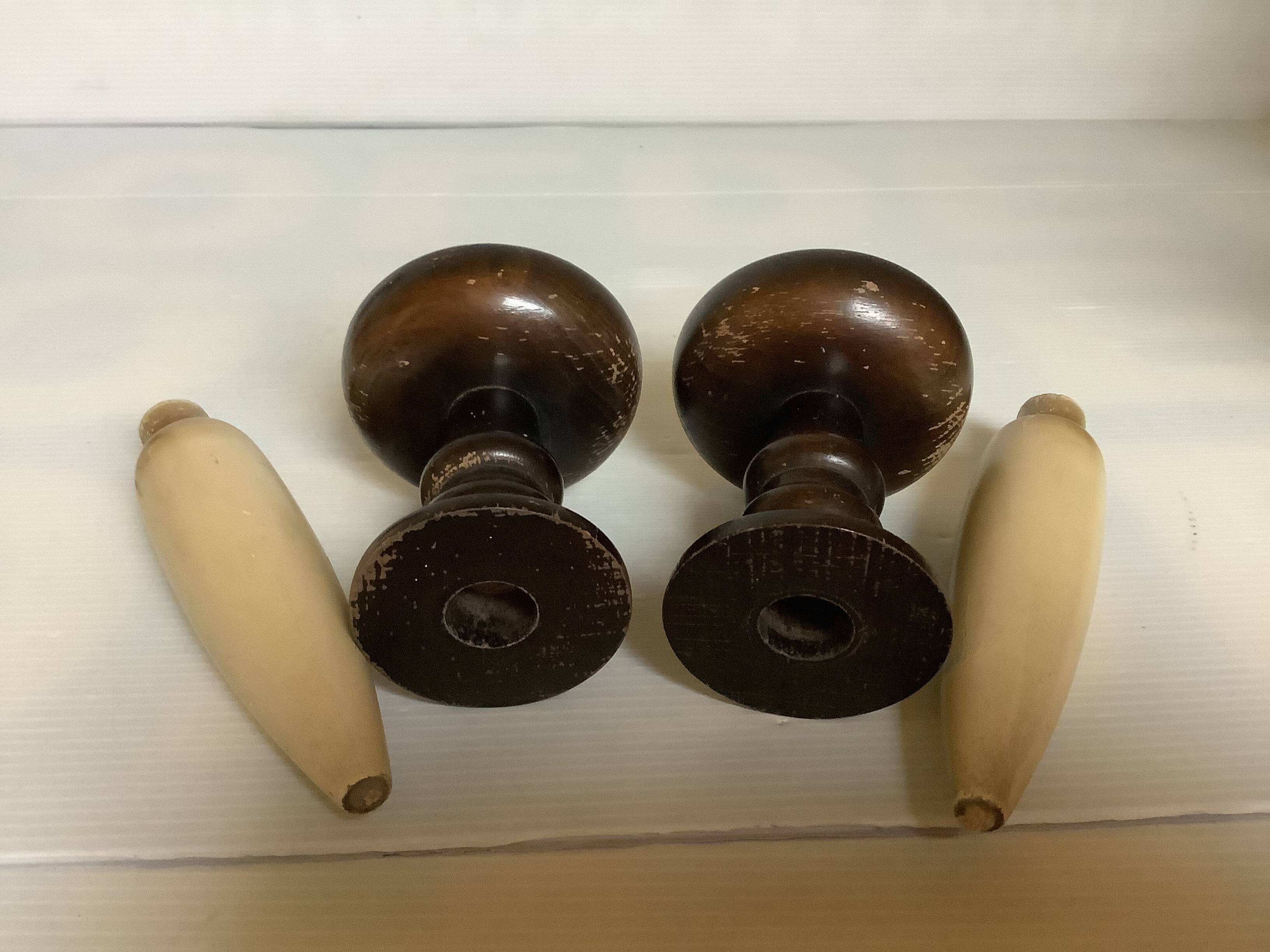 Pair of wooden candlesticks with fake wooden candles.