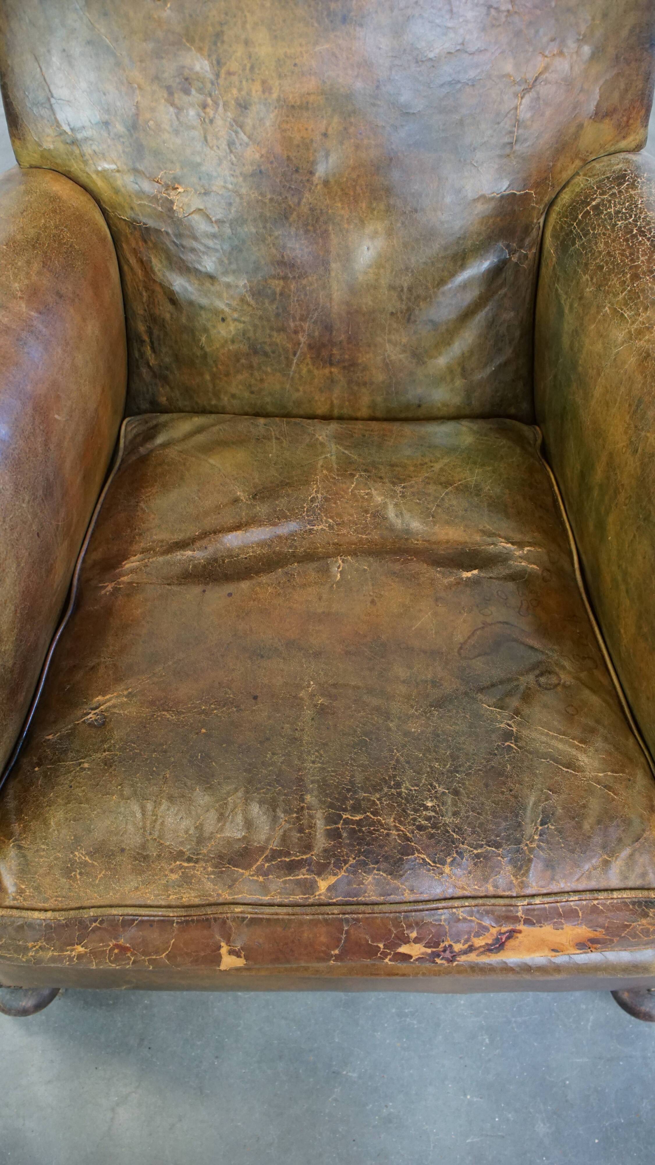 Green antique English cowhide leather armchair on wheels