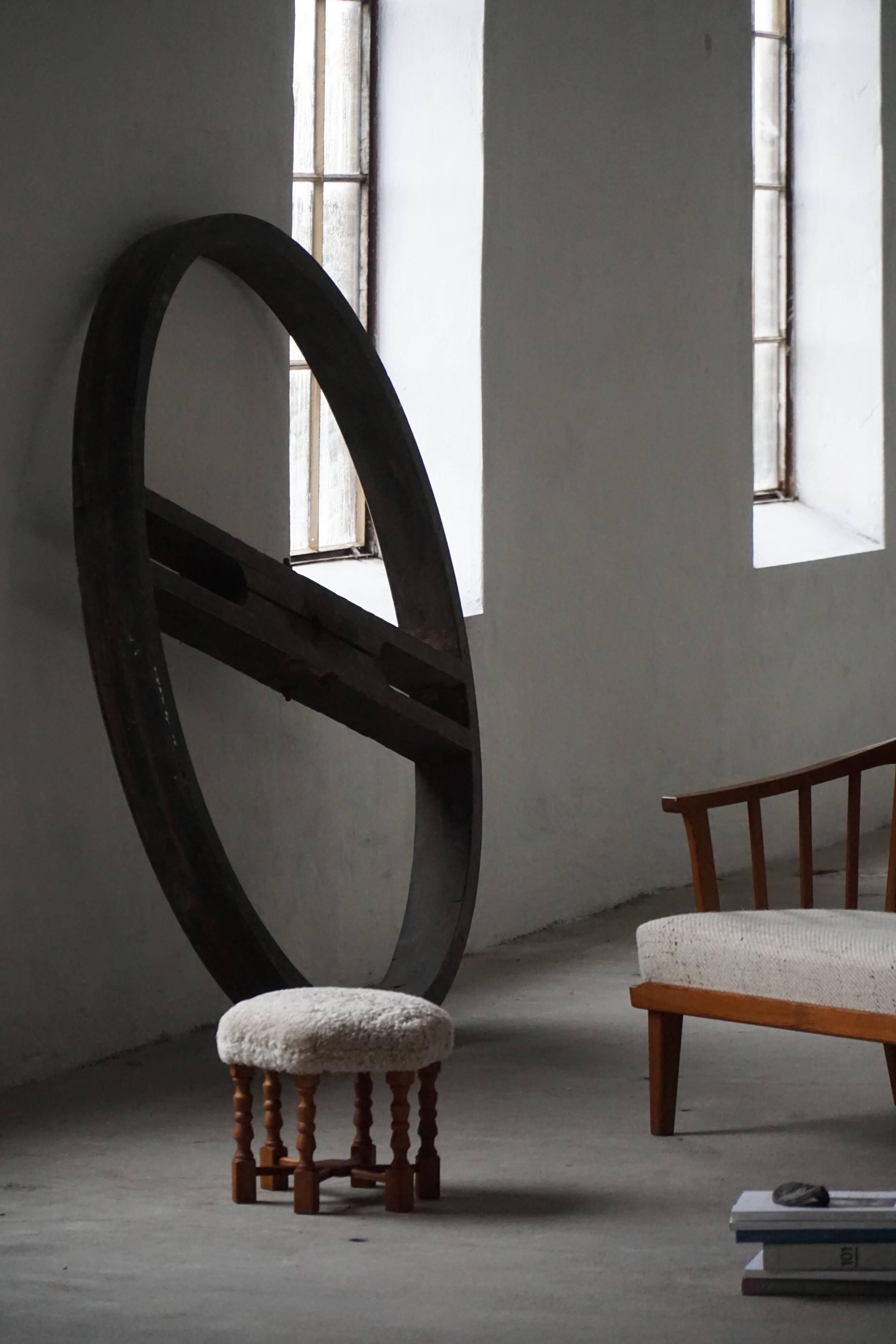 Pair of mid-century Danish oak stools with shearling lambswool upholstery, 1950s.