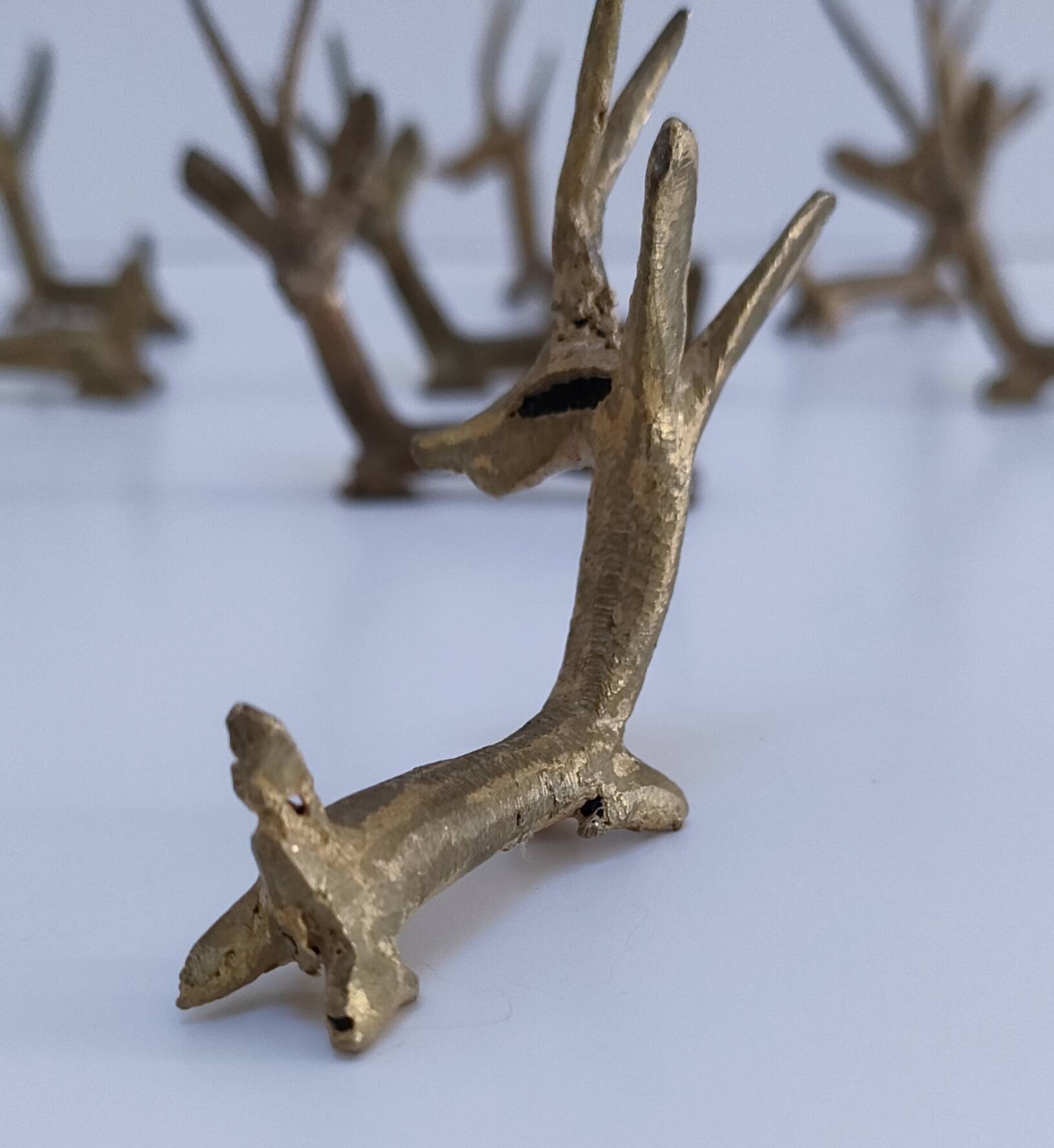 eight vintage brass Gazelle knife rests