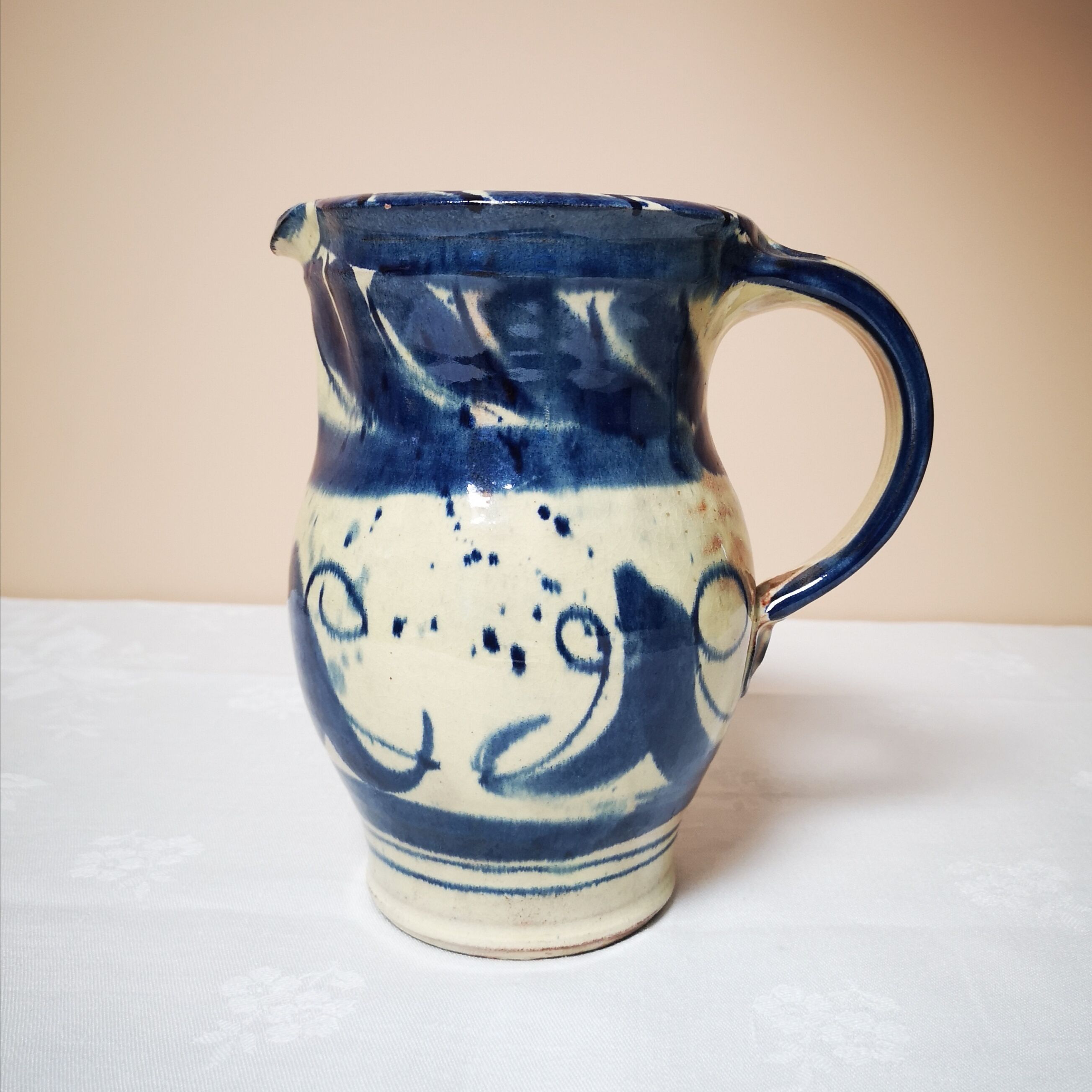 Enamelled ceramic blue pitcher signed by the artist