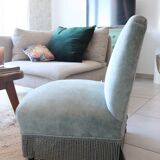 Vintage blue velvet fringed armchair.