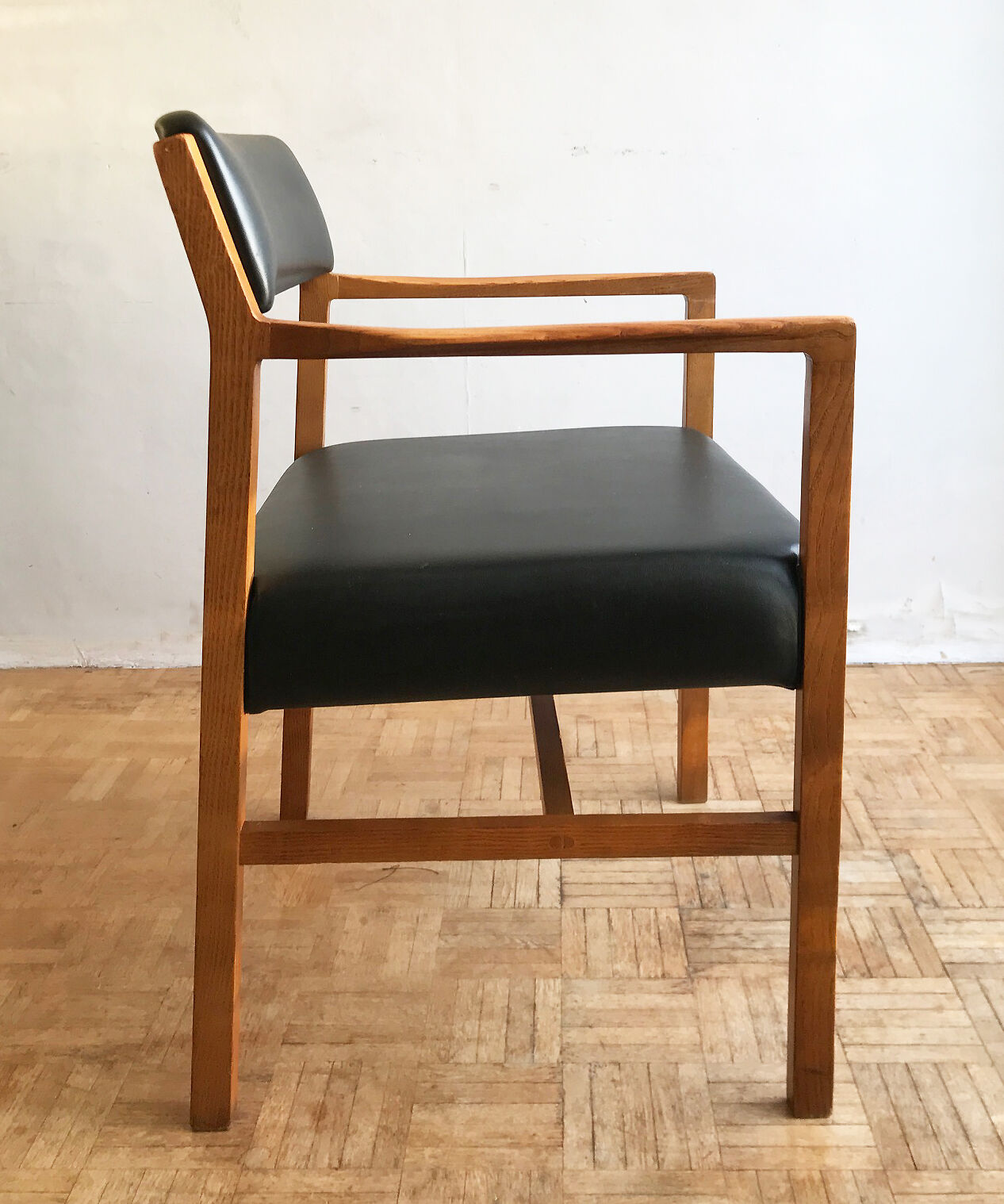 Chair in light teak and black skaï from the 1960s