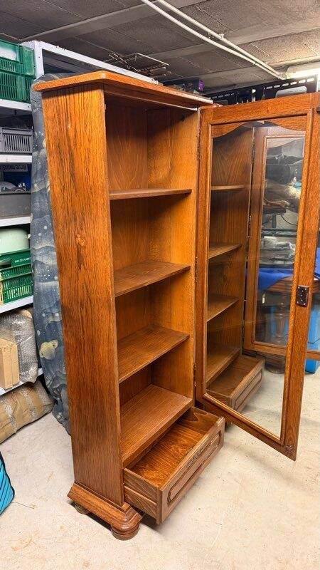 Set of 2 solid wood display cabinets with glass doors.