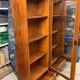 Set of 2 solid wood display cabinets with glass doors.