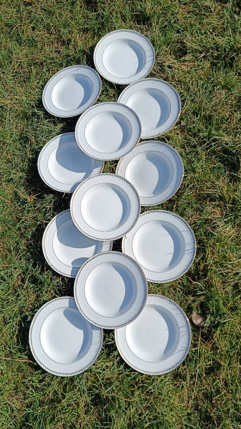 Twelve white porcelain plates