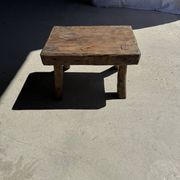 Small stool, rectangular solid teak side table with curved legs.
