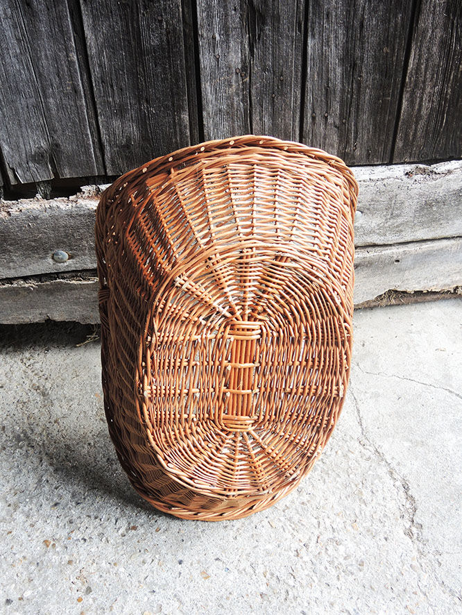 Old basket with logs in light wicker