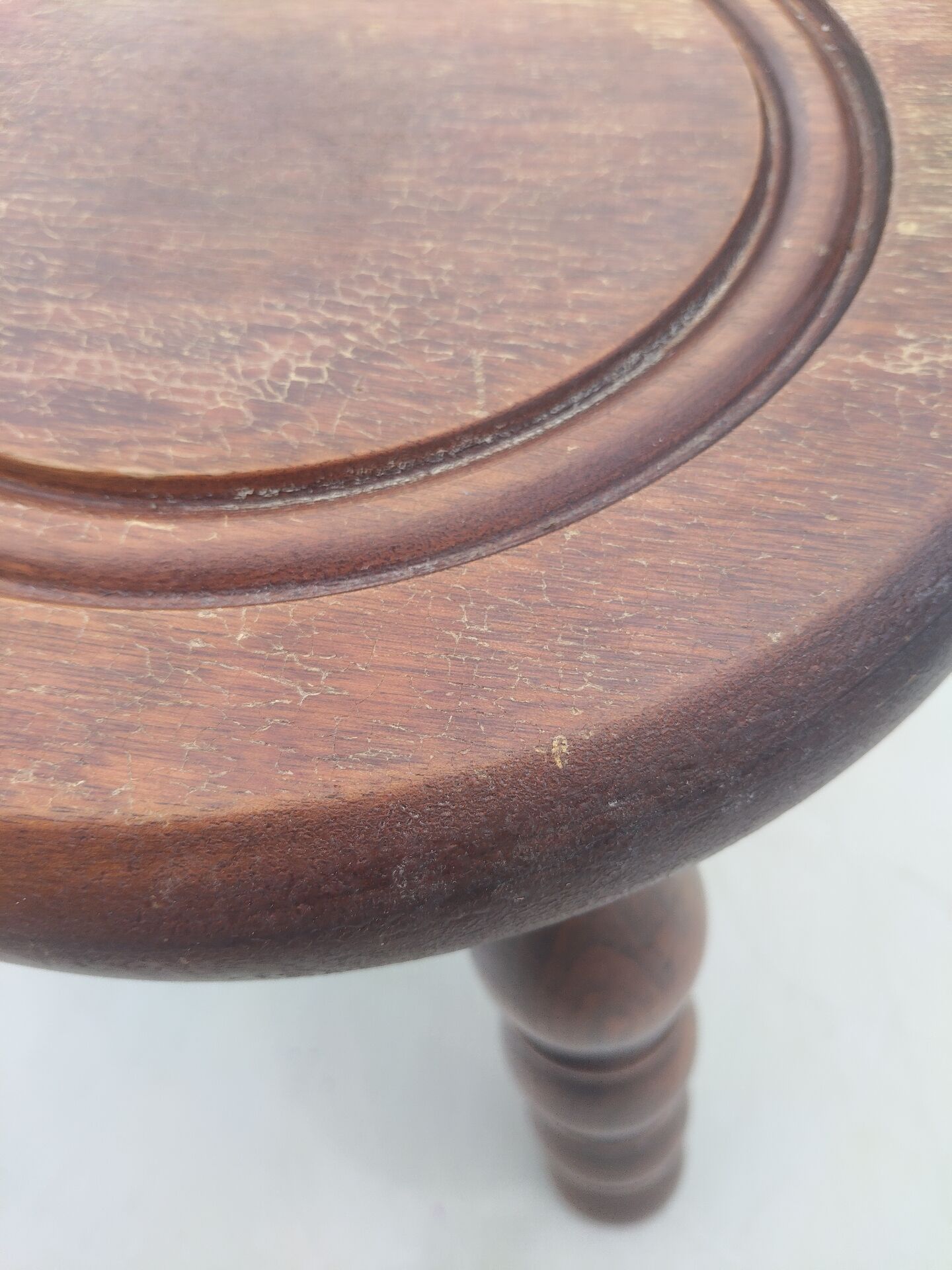 Small vintage tripod stool made of turned wood, in the style of Charles.