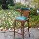 Bar stool in green leather and curved wood