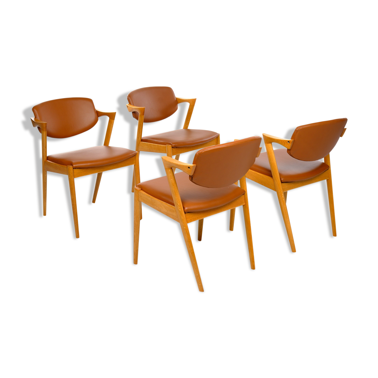 Four Kai Kristiansen oak chairs with new leather upholstery