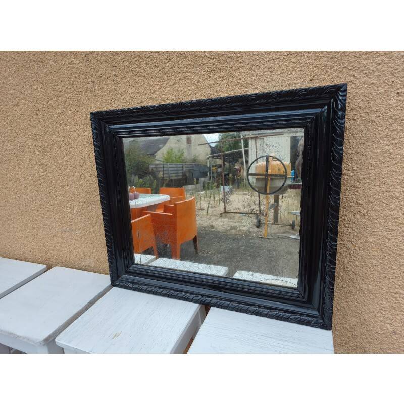 Black lacquered wood mirror "originally punctured"