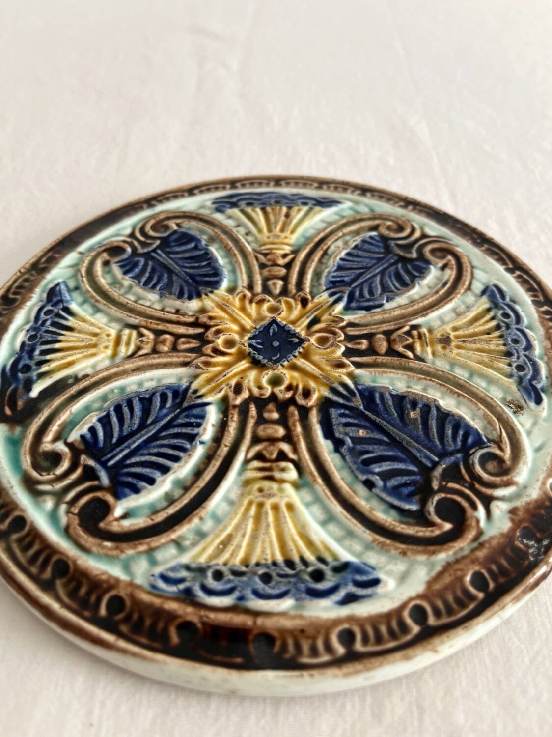 Art Nouveau earthenware bottle coaster/trivet, late 19th/early 20th century