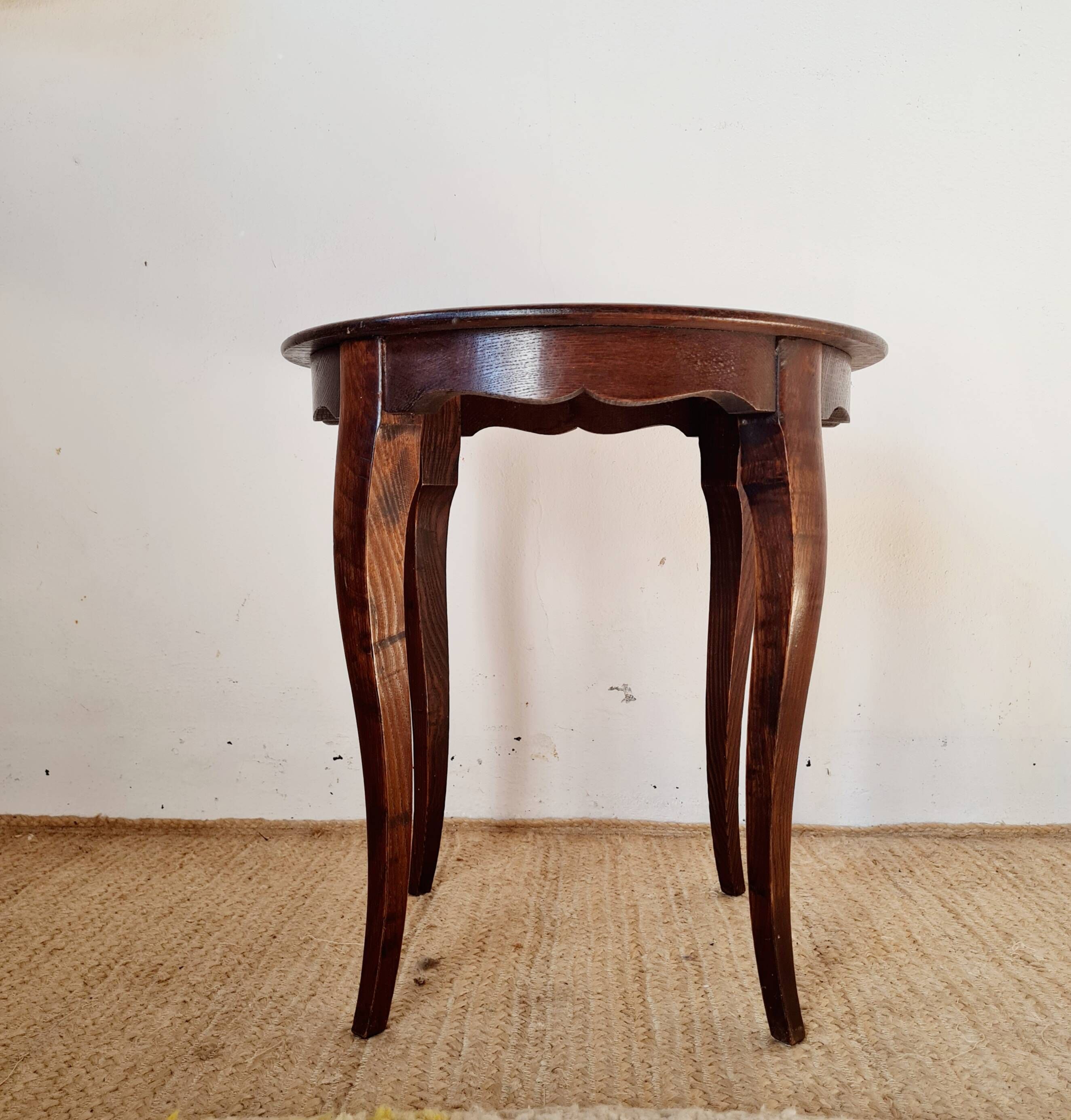 Vintage solid wood side table with curved legs.