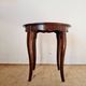 Vintage solid wood side table with curved legs.