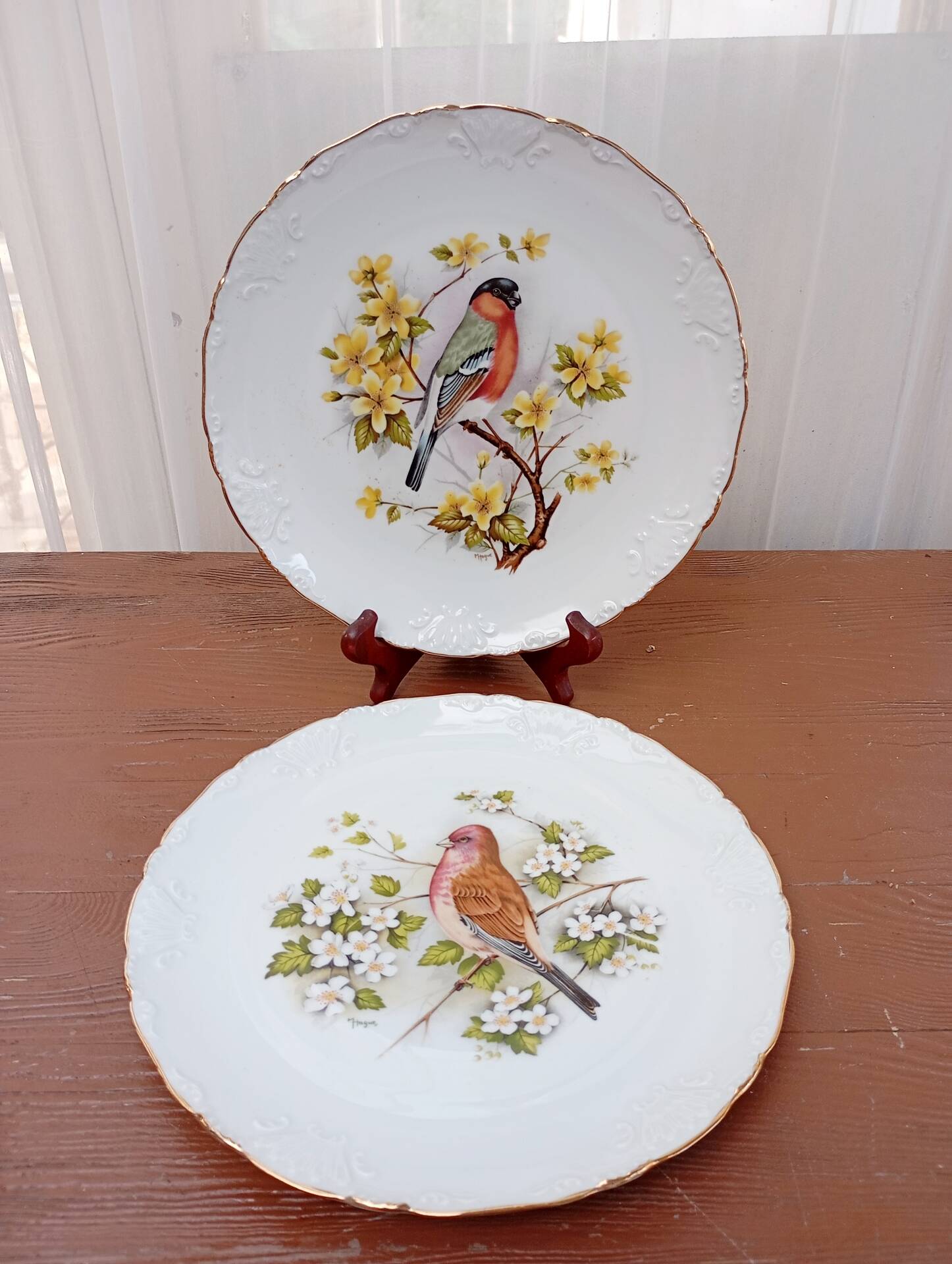 Two Limoges porcelain plates signed M. Hague.