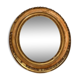 Oval mirror in wood and gilded stucco