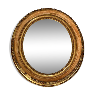 Oval mirror in wood and gilded stucco