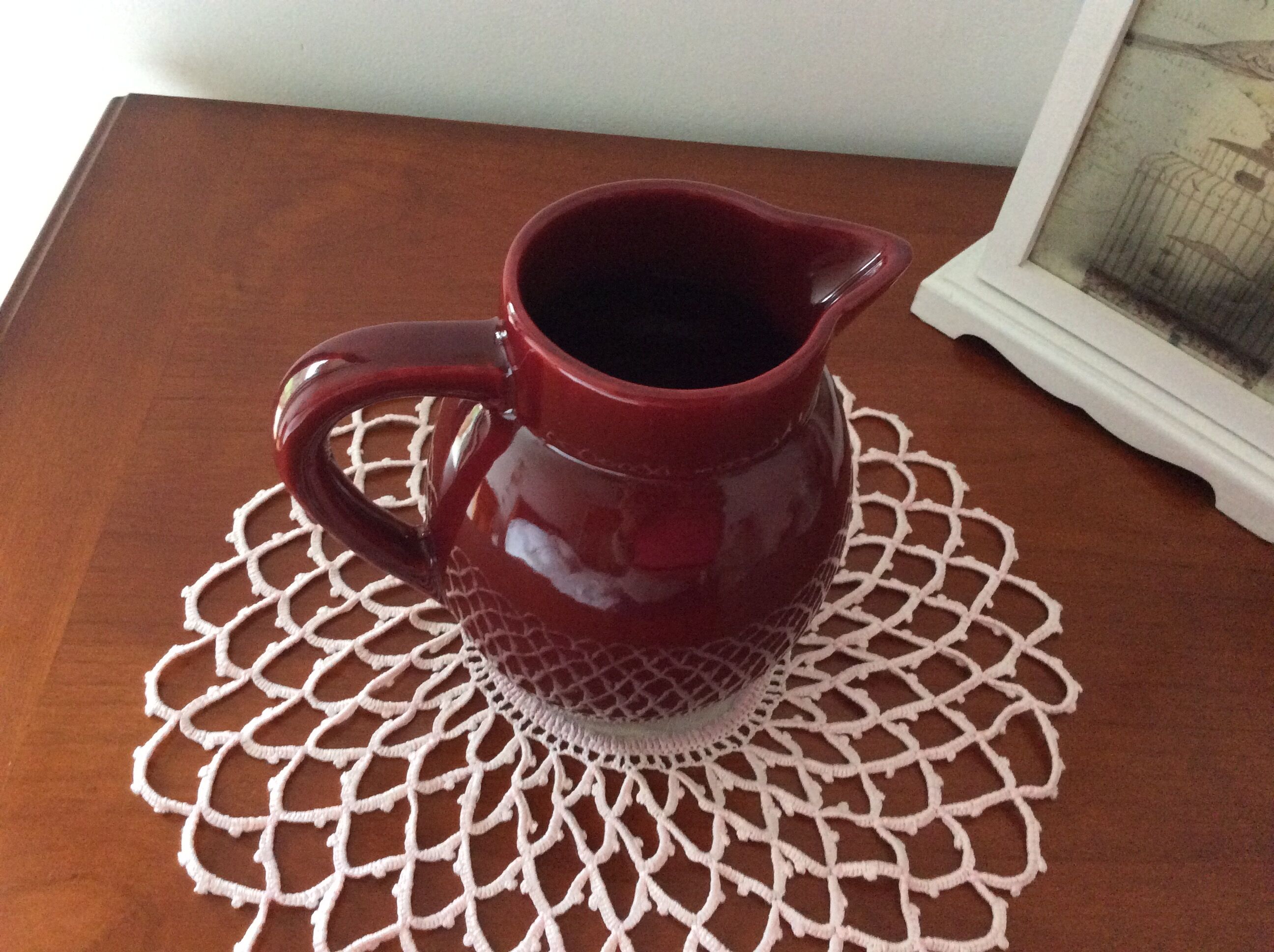 Old dark red ceramic pitcher jug