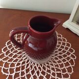 Old dark red ceramic pitcher jug