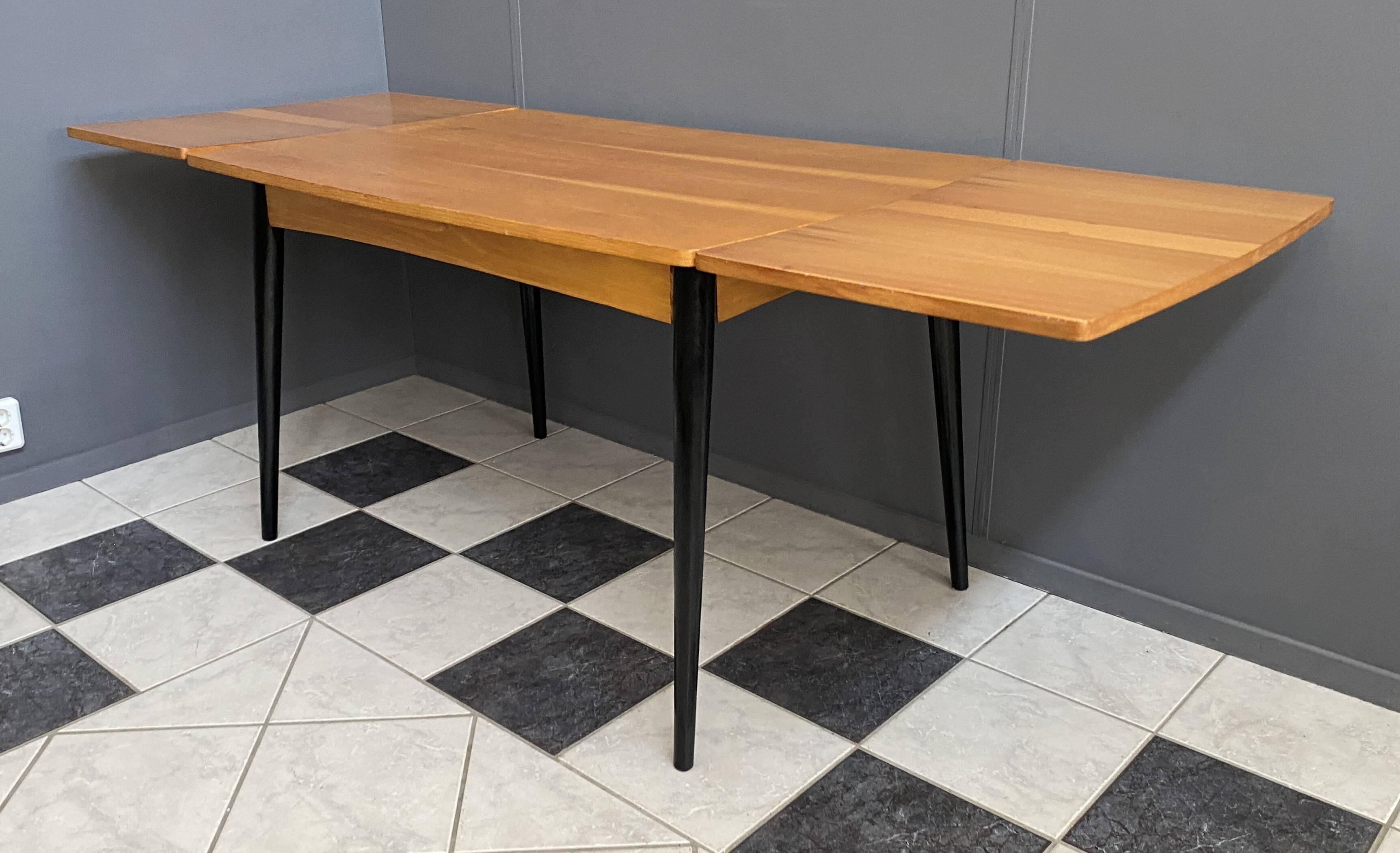 Wood enlarging dining table black wood legs 1960s
