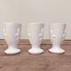 Three antique cups decorated with fleur-de-lis.