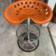 Orange tractor stool, pivoting adjustable mower, Fermigier Mirima 70.