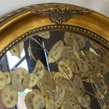 Oval-shaped gilded wooden mirror