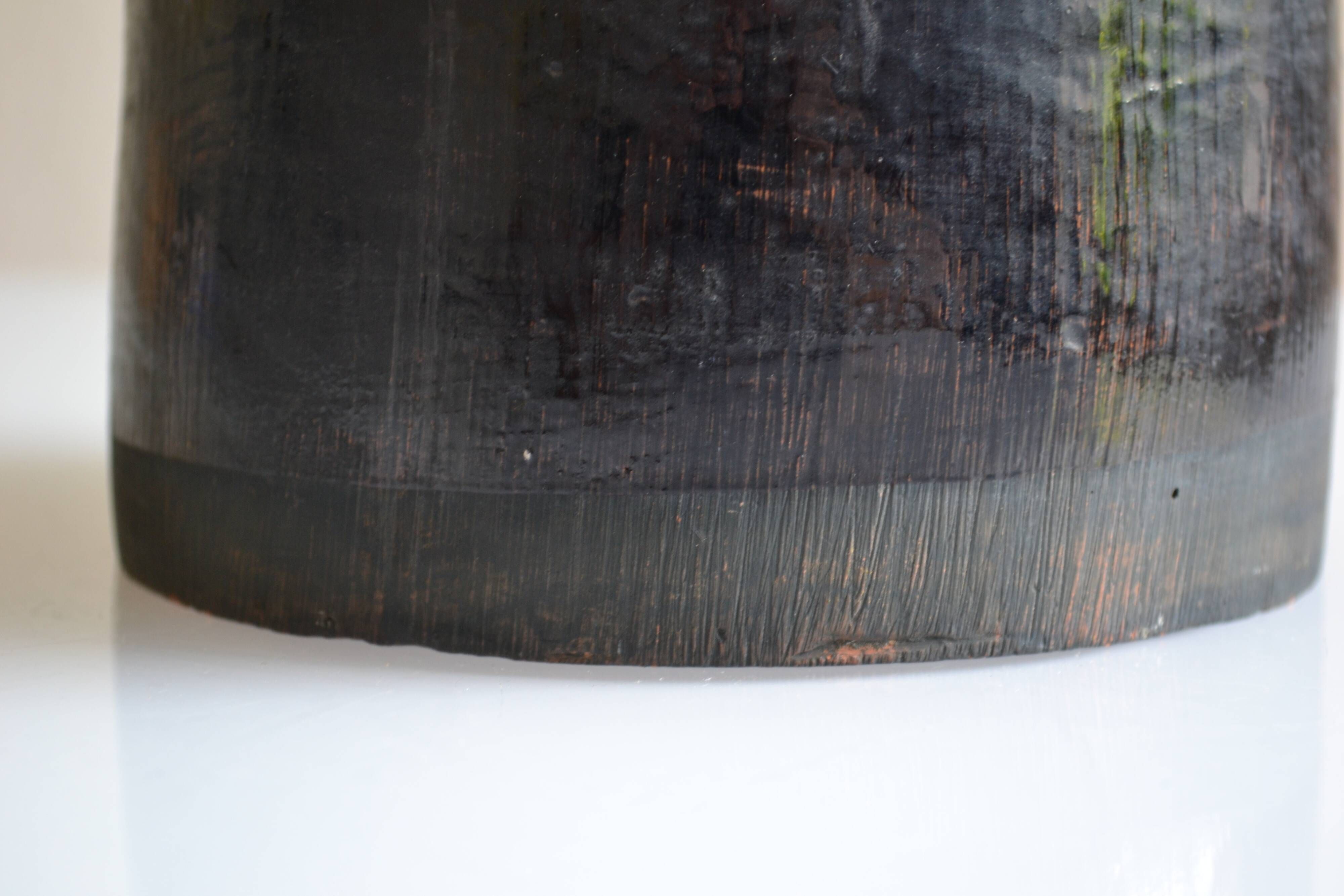 Ceramic vase with a signature fish to identify.
