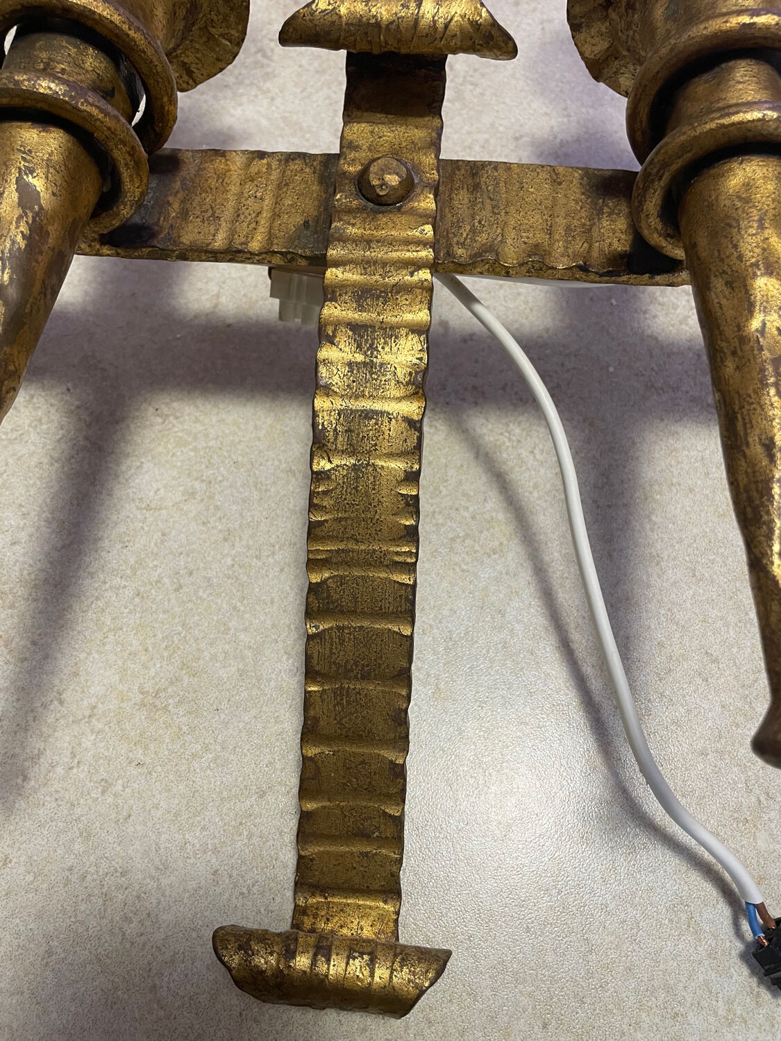 Spanish brutalist wall light in gilded wrought iron.