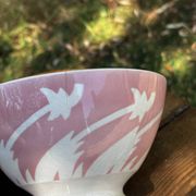 Old footed bowl in earthenware with pink decoration and defects.