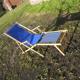 Old sunbathing in wooden & blue fabric