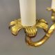 Older brass alloy chandelier with three light sources.