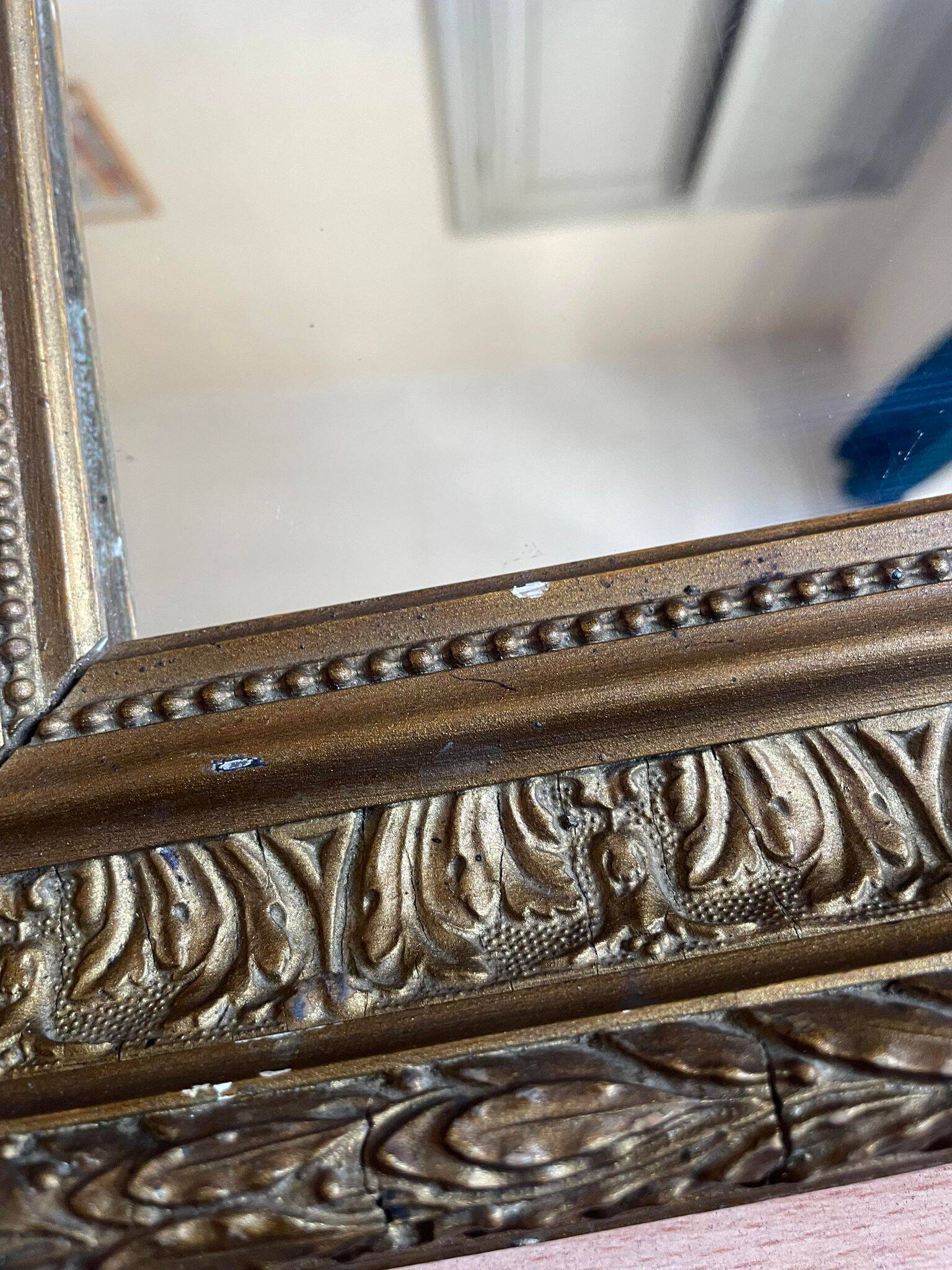Old mirror with golden wooden frame