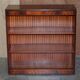 Pair of open low bookshelves Shaws of London in hardwood.